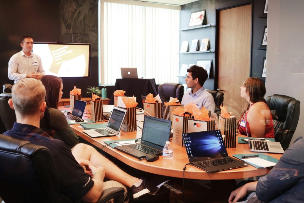 Presenter explaining to team in meeting room