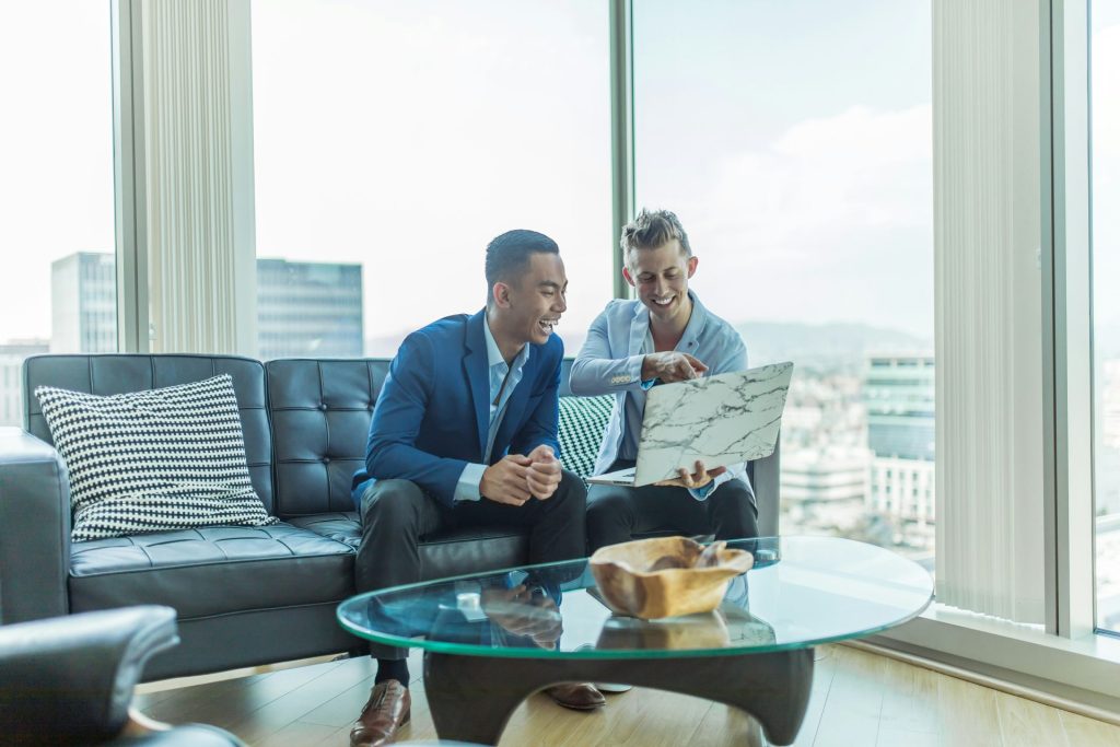 Two men discussing ideas with laptop